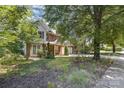 A two-story home with brick and vinyl siding, an attached two car garage and mature landscaping at 2001 Enderbury Dr, Indian Trail, NC 28079