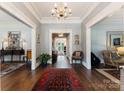 Grand foyer with detailed millwork, hardwood floors, and elegant lighting at 2324 Kingsmill Ter, Charlotte, NC 28270