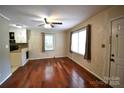 Living room with hardwood floors, ceiling fan, and natural light at 416 E Union St, Marshville, NC 28103