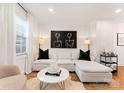 Cozy living room with white sectional, modern art, and neutral tones at 504 Wakefield Dr # A, Charlotte, NC 28209