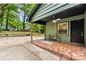 Cozy covered patio with brick flooring and a ceiling fan, perfect for outdoor relaxation at 5320 Kildare Dr, Charlotte, NC 28215
