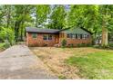 Inviting brick home with manicured lawn, showcasing its curb appeal at 5320 Kildare Dr, Charlotte, NC 28215