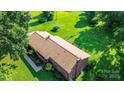 Aerial view of a brick home with a well-maintained roof and lush landscaping at 615 Bell Farm Rd, Statesville, NC 28625