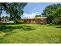 Charming brick home on a lush green lawn with mature trees at 615 Bell Farm Rd, Statesville, NC 28625