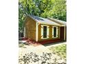 Charming home with yellow siding, white shutters, a walkway, and vibrant red landscaping at 6832 Delta Lake Dr, Charlotte, NC 28215