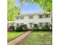 Classic two-story home with white siding, grey shutters, and a manicured lawn, offering timeless curb appeal at 7020 Leesburg Rd, Charlotte, NC 28215
