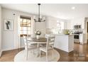 Bright kitchen with white cabinets, stainless appliances, and a cozy dining area with natural light at 7020 Leesburg Rd, Charlotte, NC 28215