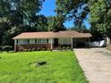 Attractive ranch home boasting a well-kept lawn, beautiful landscaping, and a convenient covered carport at 708 East St # 89, Albemarle, NC 28001
