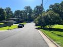 Quiet street view showcasing mature trees and the house, offering a glimpse of the peaceful neighborhood at 708 East St # 89, Albemarle, NC 28001