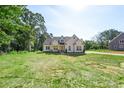 New home features architectural details and large front yard at 8680 Sherrills Ford Rd, Sherrills Ford, NC 28673