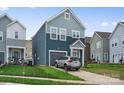 Beautiful two-story home with blue siding, a well-kept lawn, and an attached garage in a desirable neighborhood at 9025 Henry Thoreau Rd, Charlotte, NC 28214