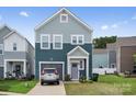 Inviting two-story home with tidy front yard, complemented by a compact garage and charming curb appeal at 9025 Henry Thoreau Rd, Charlotte, NC 28214