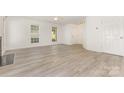 Bright living room with fireplace and new laminate flooring at 9664 Littleleaf Dr, Charlotte, NC 28215