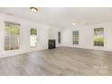 Bright and open living room featuring a fireplace, ceiling fan, and fresh paint at 9664 Littleleaf Dr, Charlotte, NC 28215