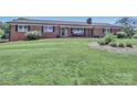 Well-kept brick home with a cozy front porch and tidy landscaping at 116 Deer Trail Rd, Statesville, NC 28677
