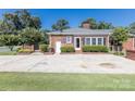 Brick home with a large paved driveway and manicured shrubbery for a welcoming entrance at 1280 Queensgate St, Gastonia, NC 28054