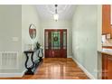 Welcoming foyer with gleaming hardwood floors, console table, and an elegant chandelier offering a warm entrance at 1313 Western Hills Ln, Vale, NC 28168