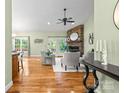 Bright living room features hardwood floors, a stone fireplace, and French doors leading to the outdoors at 1313 Western Hills Ln, Vale, NC 28168