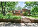 Traditional brick home with a welcoming front porch and landscaped garden at 165 Fieldstone Farm Dr, Statesville, NC 28625