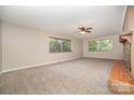 Bright living room with neutral carpet and a brick fireplace at 165 Fieldstone Farm Dr, Statesville, NC 28625