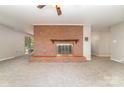 Cozy living room featuring plush carpeting and a large brick fireplace at 165 Fieldstone Farm Dr, Statesville, NC 28625
