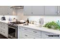Modern eat-in kitchen featuring granite countertops, backsplash, stainless steel appliances, and hardwood floors at 2008 Thatcher Way, Fort Mill, SC 29715