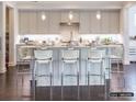 Bright eat-in kitchen features gray cabinets, a white backsplash, stainless steel appliances, and hardwood floors at 2008 Thatcher Way, Fort Mill, SC 29715