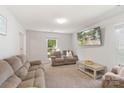 Inviting living room features neutral carpet, comfortable seating, and a large window for ample light at 2012 Killarney Pl, Charlotte, NC 28262