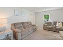 Bright and airy living room with plush seating and a view to the outdoors, creating a relaxing space at 2012 Killarney Pl, Charlotte, NC 28262