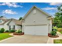 Spacious two-car garage with well-kept landscaping and symmetrical architectural details at 2026 Rosewater Ln, Indian Trail, NC 28079