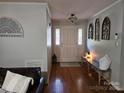 Bright foyer with beautiful hardwood floors and charming decorative accents and entryway seating at 217 Rock Creek Dr, Lincolnton, NC 28092