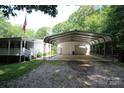 Spacious two-car garage and carport with a gravel driveway at 220 Singing Pine Dr, Clover, SC 29710