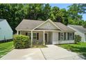 Charming single-story home features light siding, a well-manicured lawn, and a welcoming entrance at 2239 Blue Hampton Ln, Charlotte, NC 28213
