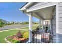 Inviting front porch with stone accents and seating, offering a relaxing outdoor space at 240 Orson Oaks Ln, Pineville, NC 28134