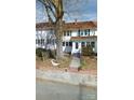 Traditional two-story home with white siding, blue shutters, and a brick-lined front yard with large tree at 29 Willow St # 31, Badin, NC 28009