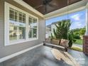 Relaxing covered porch featuring a charming porch swing at 3007 Arsdale Rd, Waxhaw, NC 28173
