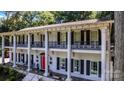 Close up of stately home with white columns, black shutters, iron railings, and red door at 327 Saint Andrews Rd, Statesville, NC 28625