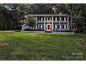 Exterior view of a traditional white home with a manicured front lawn at 327 Saint Andrews Rd, Statesville, NC 28625