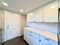 Bright kitchen featuring white cabinetry, quartz countertops, and a stylish subway tile backsplash at 419 Lige St, Rock Hill, SC 29730