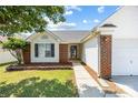 Close-up view of the exterior of the home showing manicured lawn and brick and vinyl siding details at 4697 Madeline Dr, Rock Hill, SC 29732