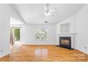 Bright living room features hardwood floors, a fireplace, a ceiling fan, and access to the backyard at 4697 Madeline Dr, Rock Hill, SC 29732