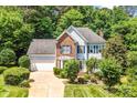 Charming two-story home featuring a well-manicured lawn, brick accents, and a two-car garage at 5238 Downing Creek Dr, Charlotte, NC 28269