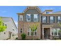 Charming townhouse exterior featuring brick facade, blue shutters, and tidy landscaping at 5337 Orchid Bloom Dr, Indian Land, SC 29707
