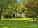 Beautifully landscaped two-story home with a lush green lawn and mature trees providing ample shade and curb appeal at 5828 Wilora Lake Rd, Charlotte, NC 28212