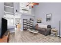 Bright living room featuring wood-look tile, vaulted ceiling, and open floor plan at 5980 Cougar Ln, Charlotte, NC 28269