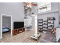 Open-concept living room boasts high ceilings, wood-look tile, and natural light at 5980 Cougar Ln, Charlotte, NC 28269