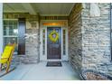 Inviting front door with stone surround, decorative wreath, and welcome mat at 6417 Loyola Ct, Mint Hill, NC 28227