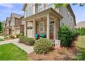 Inviting front porch with stone accents and cozy seating area at 7322 Dulnian Way, Charlotte, NC 28278