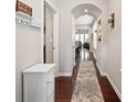 Bright hallway with hardwood floors and arched entryway leading to living area at 7322 Dulnian Way, Charlotte, NC 28278