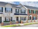 Charming townhome with a covered front porch, white picket fence, and dark shutters at 764 Atherton Way, Rock Hill, SC 29730